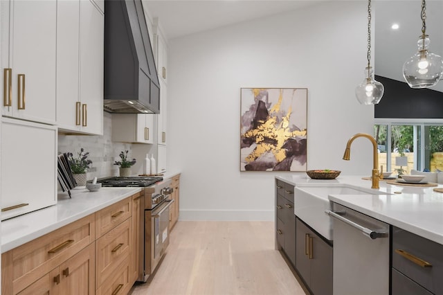 kitchen with hanging light fixtures, stainless steel appliances, lofted ceiling, light brown cabinetry, and white cabinets