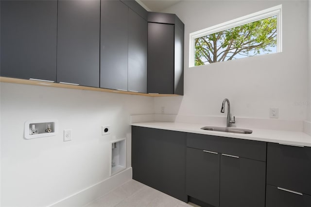 clothes washing area featuring sink, cabinets, washer hookup, electric dryer hookup, and light tile patterned floors