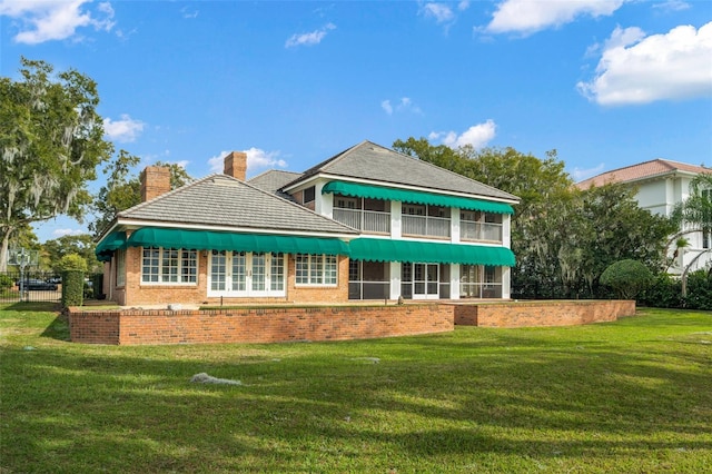 rear view of house with a lawn