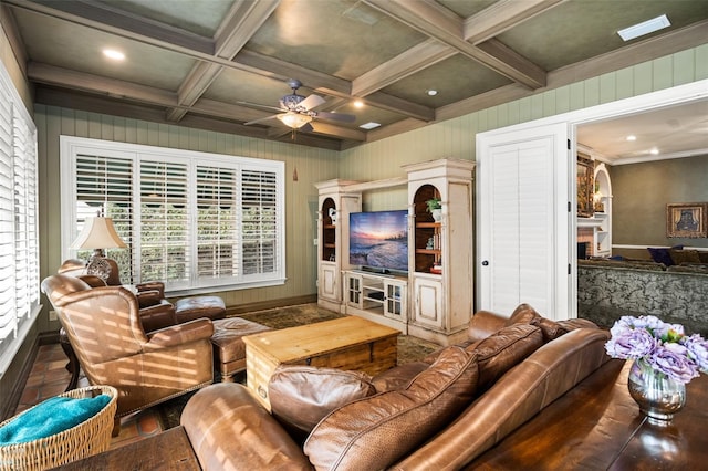 living room featuring coffered ceiling, crown molding, ceiling fan, and beam ceiling