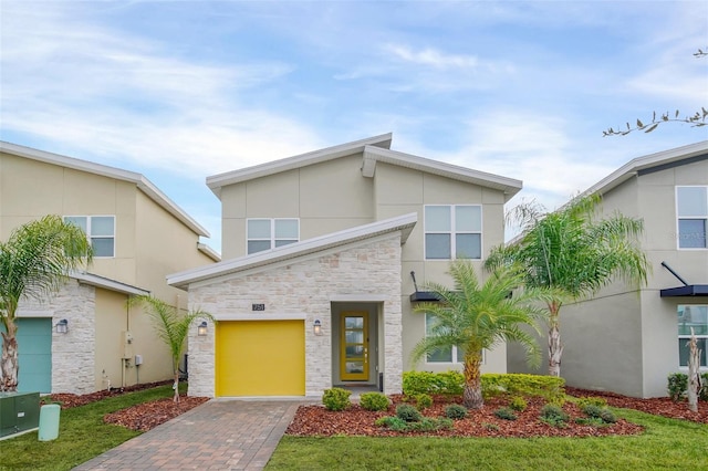 view of front of house with a front lawn and a garage