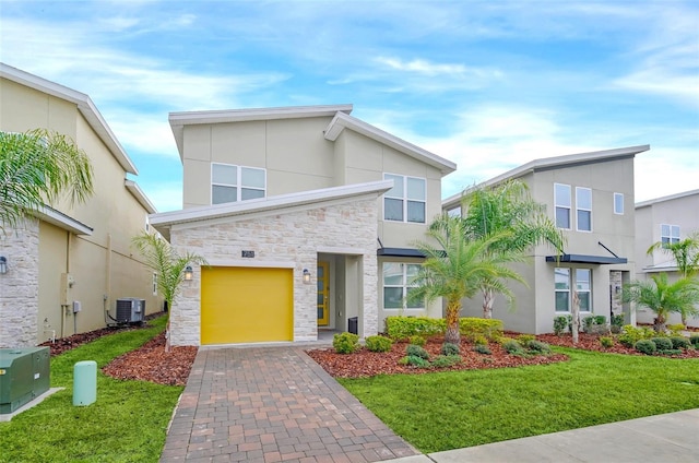 view of front of house featuring central AC and a front lawn