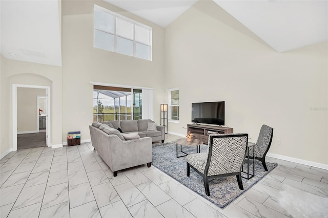 living room featuring high vaulted ceiling and light tile floors