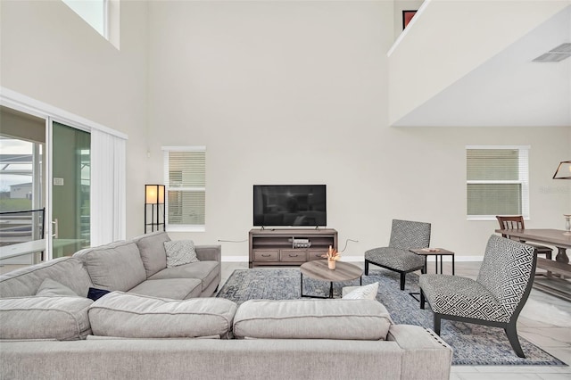 tiled living room with a high ceiling