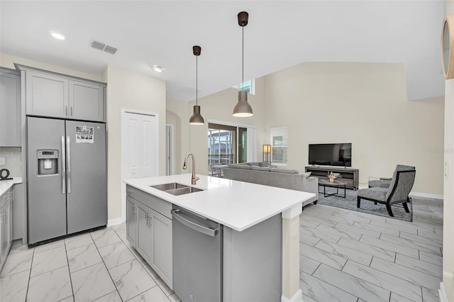 kitchen featuring gray cabinetry, light tile flooring, a kitchen island with sink, stainless steel appliances, and pendant lighting