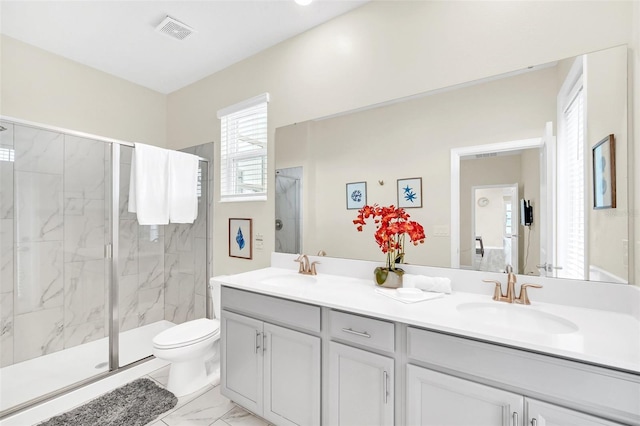 bathroom featuring toilet, a shower with door, tile floors, dual sinks, and oversized vanity