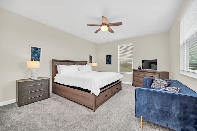 carpeted bedroom with multiple windows and ceiling fan