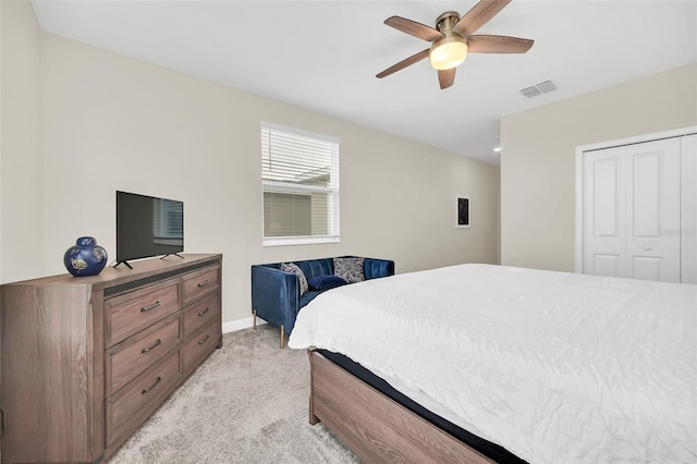 bedroom featuring a closet, ceiling fan, and light colored carpet