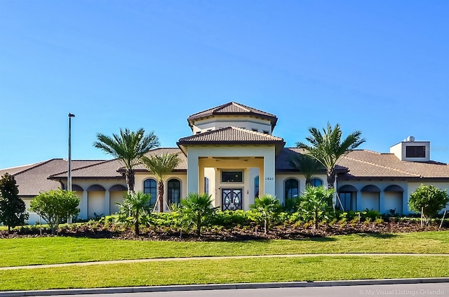 mediterranean / spanish house with a front lawn