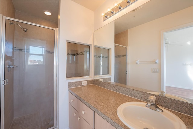 full bath featuring visible vents, a shower stall, and vanity