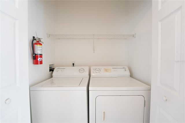 clothes washing area featuring washer and dryer and laundry area