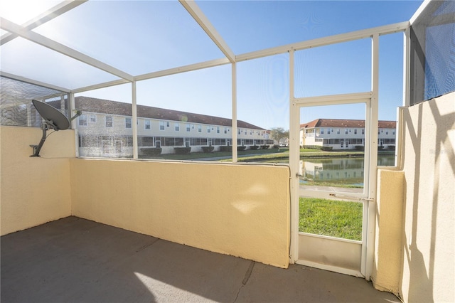 unfurnished sunroom with a water view