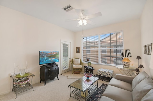 carpeted living room featuring ceiling fan