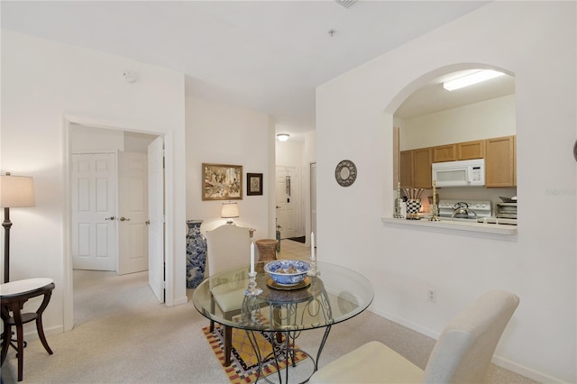 dining area with light colored carpet