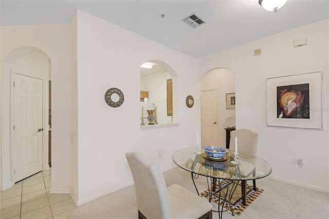 dining room with light colored carpet