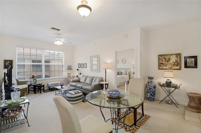 living room featuring light carpet and ceiling fan