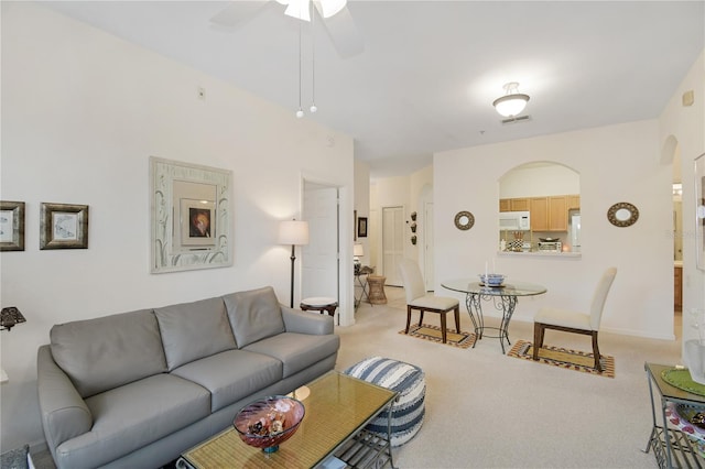 living room with light carpet and ceiling fan