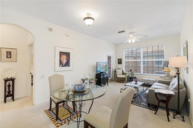 13524 Turtle Marsh Loop Unit 638, Orlando, FL 32837 - dining room with arched walkways, ceiling fan, light colored carpet, and baseboards