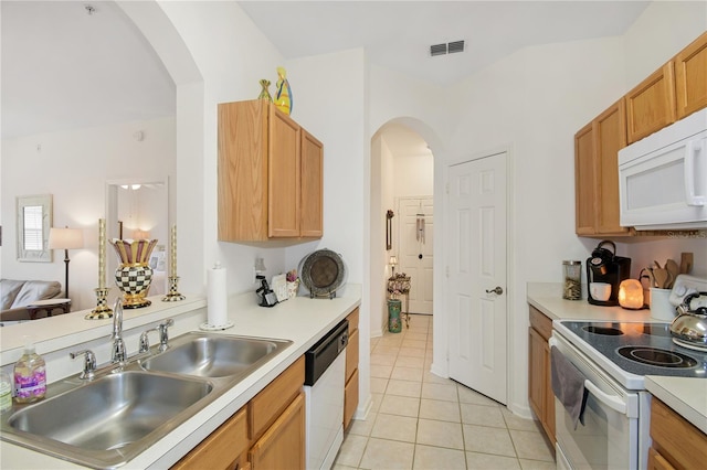 kitchen featuring light tile patterned flooring, sink, and white appliances