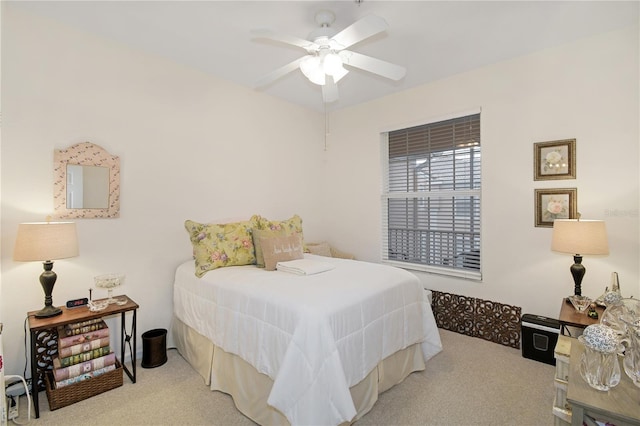 bedroom featuring light carpet and ceiling fan