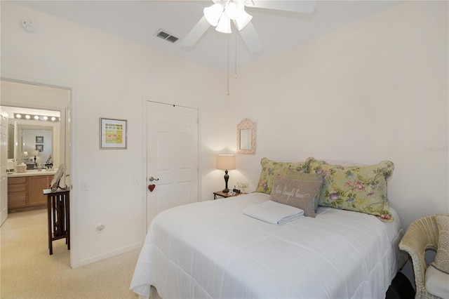 13524 Turtle Marsh Loop Unit 638, Orlando, FL 32837 - bedroom featuring light carpet, baseboards, ceiling fan, and ensuite bath
