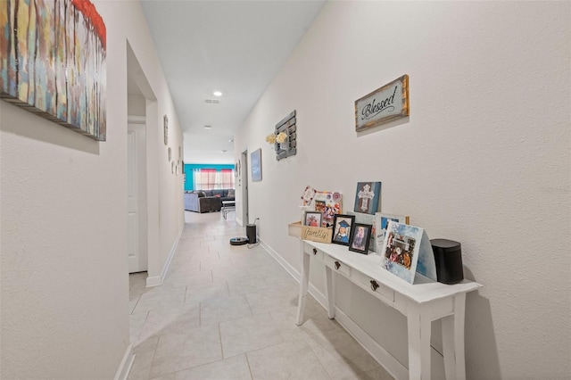 hall featuring light tile flooring