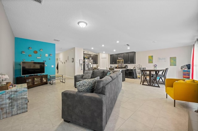 tiled living room with a textured ceiling