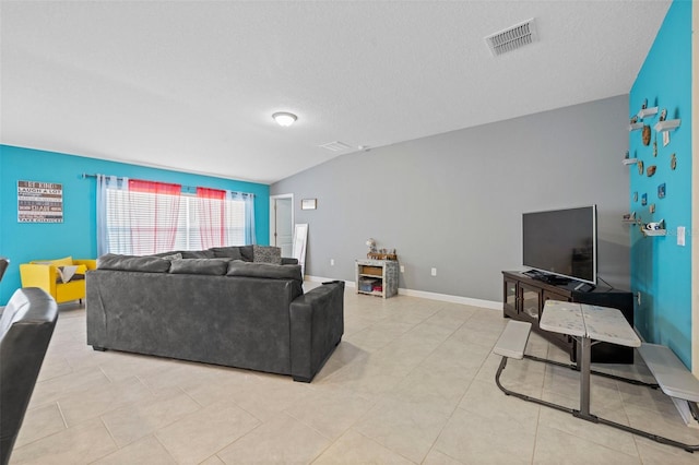 tiled living room with a textured ceiling and vaulted ceiling