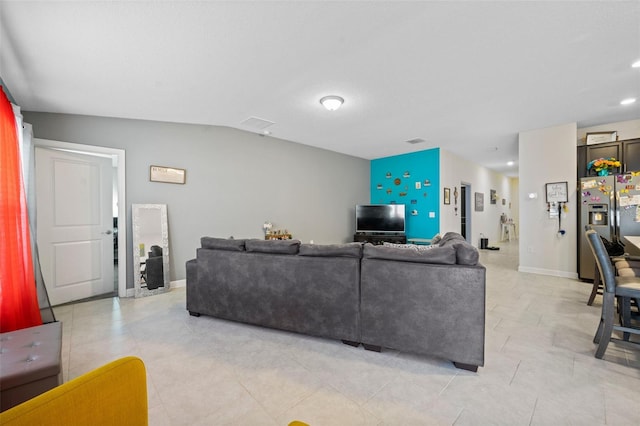 tiled living room with lofted ceiling