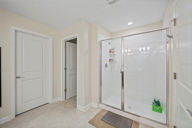 bathroom with tile floors and an enclosed shower