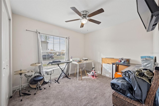 miscellaneous room with ceiling fan and carpet