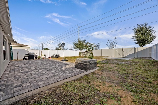 view of yard with a fire pit and a patio