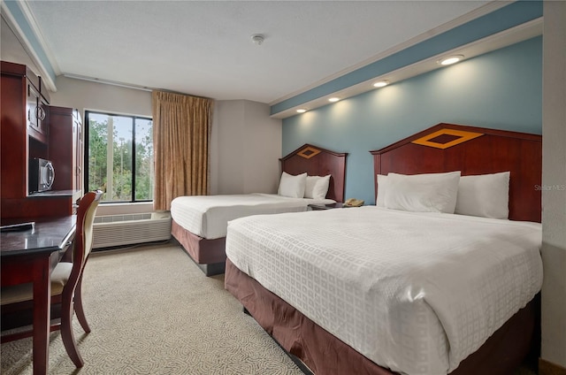 bedroom with crown molding and light colored carpet