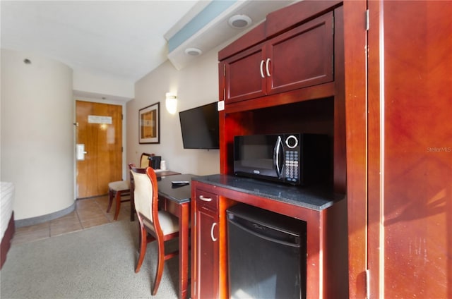 kitchen with light carpet and refrigerator