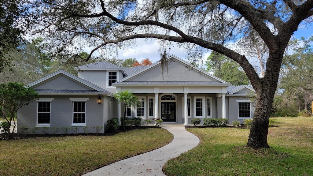 neoclassical / greek revival house with a front yard