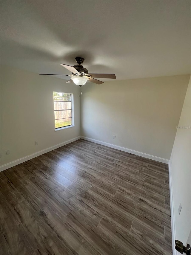 spare room with ceiling fan and dark hardwood / wood-style flooring