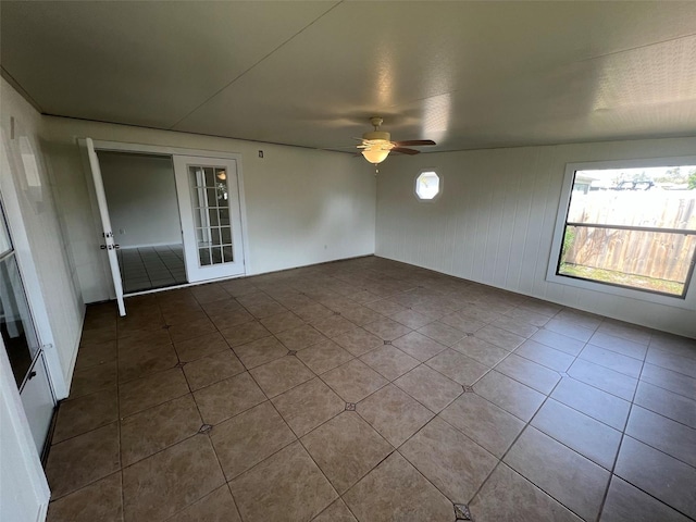 interior space with ceiling fan and tile patterned flooring