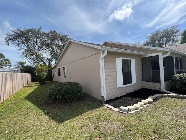 6425 Stillwater Ave, Cocoa, FL 32927 - view of property exterior featuring a sunroom, fence, and a lawn