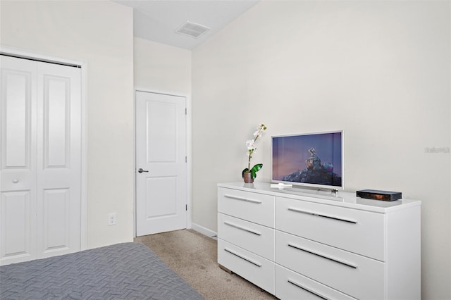 carpeted bedroom with a closet