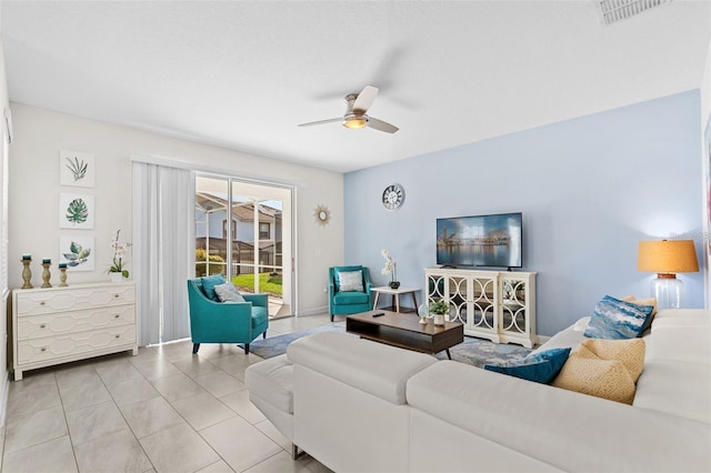 tiled living room featuring ceiling fan