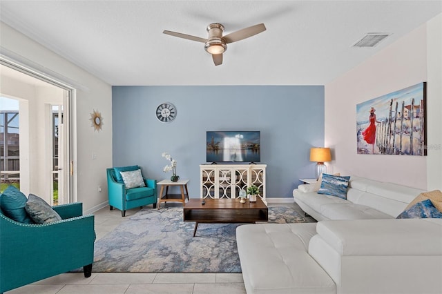 tiled living room with ceiling fan