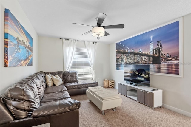 carpeted living room with ceiling fan