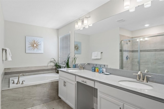 bathroom featuring double sink, tile flooring, vanity with extensive cabinet space, and shower with separate bathtub