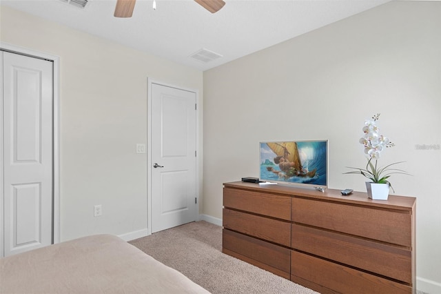 bedroom with light carpet, a closet, and ceiling fan