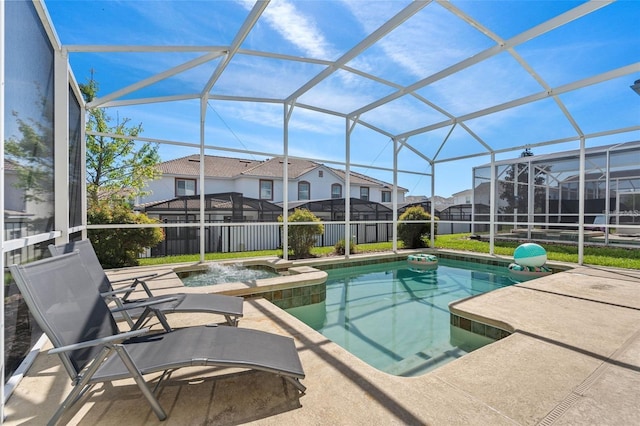 view of pool featuring an in ground hot tub, glass enclosure, and a patio