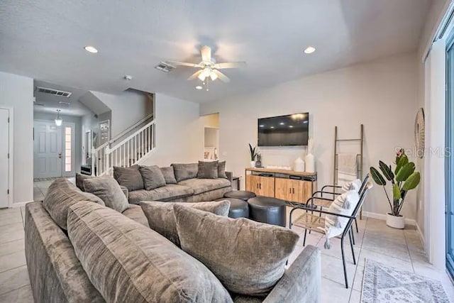 living room with light tile floors and ceiling fan