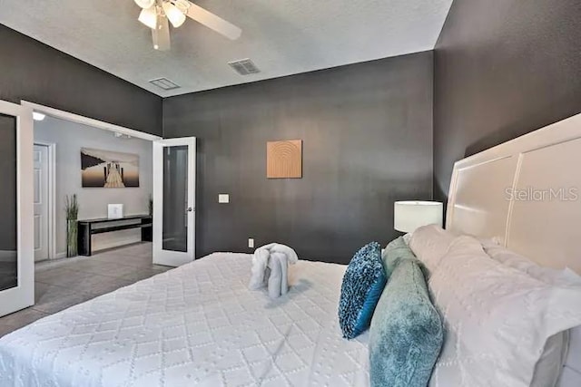 bedroom featuring ceiling fan and french doors