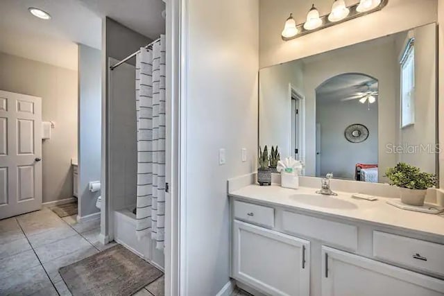 full bathroom with vanity, ceiling fan, tile floors, toilet, and shower / tub combo