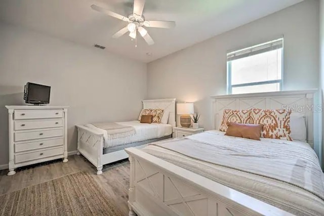 bedroom featuring ceiling fan and dark hardwood / wood-style flooring