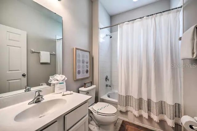 full bathroom with vanity, shower / tub combo with curtain, and toilet